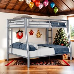 a bunk bed in a room with christmas decorations on the ceiling and balloons hanging from the ceiling