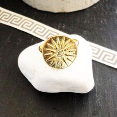 "Buy an original Greek Gold Vergina Sun Ring | Discover Greek Jewelry within a huge collection of Ancient Greek Jewelry | shipping worldwide Materials sterling silver 925, 14K gold plated One beautiful adjustable ring represents \"Macedonia\" . --The Vergina Sun (Greek: Ήλιος της Βεργίνας, also known as the \"Star of Vergina\", \"Macedonian Star\" or \"Argead Star\") is a rayed solar symbol appearing in ancient Greek art of the period between the 6th and 2nd centuries BC. The ring is sterling si Gold Spiritual Signet Ring For Gift, Gold Spiritual Signet Ring As A Gift, Gold Spiritual Rings With Polished Finish, Celestial Style Gold Round Rings, Handmade Celestial Yellow Gold Rings, Celestial Gold Rings In Sterling Silver, Celestial Gold Sterling Silver Rings, Celestial Style Gold Signet Ring As Gift, Gold Celestial Engraved Rings