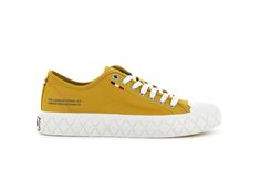 a yellow tennis shoe with white laces