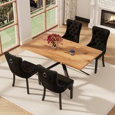 a dining room table with black chairs and a fire place in the fireplace behind it