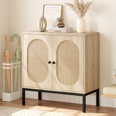 a wooden cabinet with two doors and some plants on top of it next to a chair