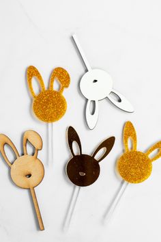 some bunny and rabbit shaped cake toppers on sticks