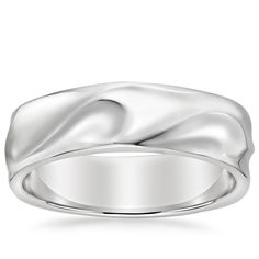 a white gold wedding ring with an elegant design on the outside, and a smooth surface