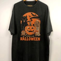 Retro Halloween Shirt, Long Live Halloween, Vintage Halloween Shirt Discover Our Newest Collection Of Stylish And Adaptable T-Shirts (Gildan 5000), Where Fashion Meets Comfort! Available In A Wide Range Of Sizes From S To 3xl And Lively Color Choices Including Black, White, Sand, Green, Sport Grey, Red, Navy, And More, Ensuring There's Something For Everyone. Carefully Crafted With Premium Materials, Our T-Shirts Offer A Luxurious Feel And A Snug Fit That Lasts All Day. Engineered To Withstand F Retro Black Shirt For Fall, Halloween Streetwear Cotton Shirt, Black Graphic Print Shirt For Halloween, Grunge Halloween Streetwear Shirt, Black Retro T-shirt For Fall, Black Grunge Shirt For Halloween, Black Horror Shirt For Halloween, Black Band Merch Shirt For Fall, Black Cotton Shirt For Halloween