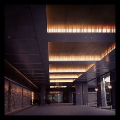 an empty lobby with lights on the ceiling