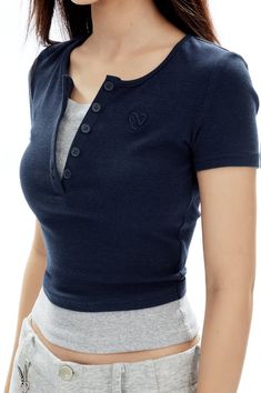 Revamp your everyday look with the allure of the Ribbed Henley Mock Two-Piece Short Sleeve Crop Top. This piece is a seamless fusion of sophistication and understated *style, crafted from a quality blend of 48% cotton and 52% synthetic fibers, including a touch of spandex for that flawless fitted silhouette. The V-neckline and ribbed texture add a classic touch, while the mock two-piece design offers a trendy, layered appearance without the bulk. Elevate your casual repertoire by pairing it with Henley Tank Top Outfit, Henley Top Outfit, Crop Top Layering, Top Layering, Crop Top Style, Grunge Accessories, Simple Wardrobe, Understated Style, Tank Top Outfits