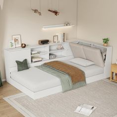 a white bed sitting on top of a wooden floor