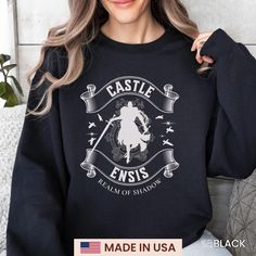 a woman wearing a black sweatshirt with the words castle enniss and an image of a horse on it