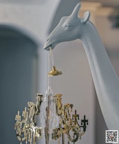 a giraffe figurine is hanging from a chandelier