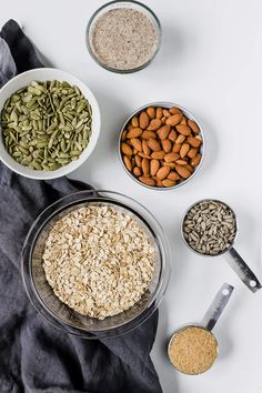 bowls filled with different types of seeds on top of a table