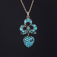 Perhaps the oldest stone in man's history, turquoise has long been a prized symbol of wisdom and nobility. This elegant pendant was converted from an antique brooch (circa 1860-1880) by removing the pin and adding a 14k gold bail. The piece features a bow and heart of turquoise cabochons set in gilded silver. The reverse bears a small locket that contains woven human hair. The pendant measures 1.8 inches from the top of the bail to bottom by 0.9 inches wide and is in great condition. We are prov Turquoise Brooch For Formal Occasions, Antique Turquoise Gemstone Jewelry, Ornate Turquoise Jewelry For Collectors, Antique Hallmarked Turquoise Jewelry, Victorian Turquoise Pendant Jewelry, Victorian Turquoise Gemstone Jewelry, Antique Turquoise Engraved Jewelry, Victorian Hallmarked Turquoise Jewelry, Antique Engraved Turquoise Jewelry