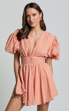 Xandy Mini Dress - Textured Puff Sleeve Plunge Dress in Peach | Showpo USA Spring Peach Dress With Smocked Back, Spring Orange Mini Dress With Puff Sleeves, Summer Orange Puff Sleeve Mini Dress, Orange Puff Sleeve Dress For Brunch, Peach V-neck Spring Dress, Coral Dress For Spring Brunch, Orange Short-sleeved Mini Dress For Day Out, Peach V-neck Mini Dress For Beach, Chic Orange Cotton Mini Dress