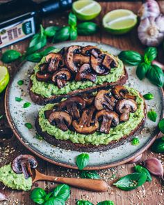 two slices of toast topped with mushrooms and guacamole