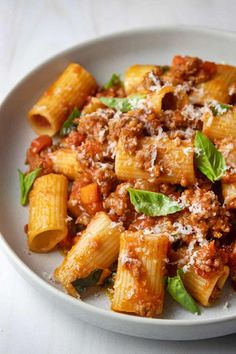 a white plate topped with pasta covered in sauce