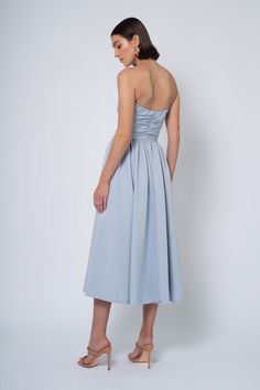 The Regina dress is a chic and versatile option for any stylish event. She features a sleek, straight strapless neckline, detachable puff sleeves, a flirty midi length dirndl skirt, and everyone’s favorite, POCKETS! Tea Length Dress With Fitted Bodice For Prom, Chic Tea-length Bridesmaid Midi Dress, Chic Tea Length Bridesmaid Midi Dress, Fitted Midi Dress With Ruched Bodice, Fitted Midi Dress With Straight Neckline For Prom, Gala Tea Length Dress With Fitted Bodice, Gala Midi-length Dress With Fitted Bodice, Chic Bridesmaid Midi Dress With Pleated Bodice, Midi Dress With Lined Bodice For Prom