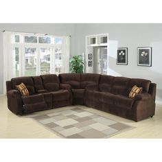 a living room with a large sectional couch in the center and two recliners on the other side