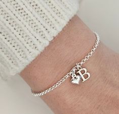 925 Sterling Silver initial and Puff heart Bracelet. A wonderful piece to add to your jewellery collection or for gifting to someone special. This Bracelet is made with 2x2mm link size Sterling silver Belcher Chain, and Sterling silver 9mm letter charm and a 6mm Sterling silver puff heart charm. Complete with a 925 hallmark tag located at the end of the chain. Each bracelet comes complete with our Branded gift box. Each Bracelet is made to order so rest assure you will receive your very own 'esp Dainty Sterling Silver Charm Bracelet With Heart Charm, Silver Name Bracelet With Heart Charm For Gift, Silver Name Bracelet With Heart Charm As Gift, Silver Name Bracelet With Heart Charm, Silver Sterling Name Bracelet With Heart Charm, Sterling Silver Name Bracelet With Heart Charm For Anniversary, Silver Heart-shaped Name Bracelet In Sterling Silver, Silver Heart-shaped Sterling Silver Name Bracelet, Sterling Silver Heart Bracelet With Charms