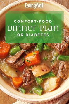 a bowl filled with meat and vegetables on top of a wooden table