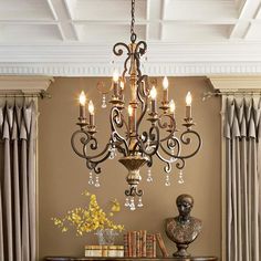 a chandelier hanging from the ceiling in a living room