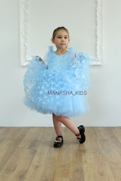 We are delighted to offer you a charming handmade children's dress that is exclusively made to order. This unique dress is crafted from tulle fabric adorned with delicate butterfly lace, adding a touch of elegance and lightness to the design. The dress features a full skirt that falls below the knee, creating a fairytale silhouette that makes your child feel like a true princess. The open back adds a touch of sophistication and refinement. Special accents are the bows that adorn the back and shoulders, adding originality and a festive flair. Available in the following colors: - White - Black - Pink - Blue - Powder Order this enchanting dress now using our standard size chart. If you prefer a custom order, contact us, and we will happily create a dress to your specific measurements, ensurin Whimsical Dress-up Tulle Dress, Whimsical Tulle Skirt Dress For Dress-up, Princess Style Organza Tutu Dress For Baptism, Whimsical Tulle Dress, Blue Princess Dress For First Birthday In Spring, Whimsical Tulle Dress For Baptism, Whimsical Tulle Dresses For Baptism, Whimsical Tulle Baptism Dress, Blue Tulle Dress For First Birthday