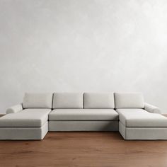 a white couch sitting on top of a wooden floor