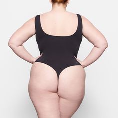 The Smoothing Bodysuit is the perfect everyday essential for light smoothing and support for your waist. Features a double scoop neck and a thong back that makes it seamless under clothing. | SKIMS Thong Bodysuit | Black | Soft Smoothing Seamless Bodysuit Black, Tights Outfit, Tan Skin, Fall Shopping, Personal Marketing, Black Bodysuit, Bra Sizes, Scoop Neckline, Everyday Essentials Products