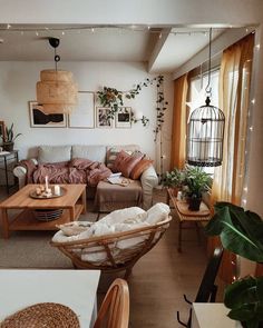 a living room filled with furniture and plants