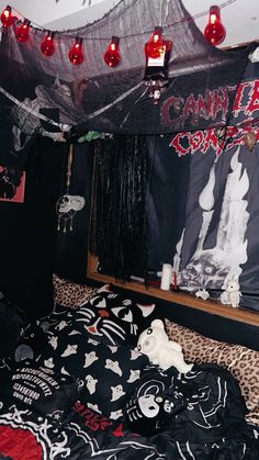 a bedroom decorated for halloween with black and red decorations on the walls, leopard print bedspread