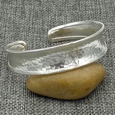 "❋ Handmade Sterling Silver Cuff Bracelet, Hammered Shiny Silver, a little Concave and Framed edges ❋ Width: 9/16 inches (1.5cm) ❋ Size: Medium -large for women/ Small- Medium for man, the Length of the cuff is 6 11/16 inches (6.7\"/ 17cm) ❋ Metal Purity: 95% Pure Silver (Purer than sterling Silver - 92.5%) 5/16 inches Wide: https://www.etsy.com/listing/873886505/ Wider versions: https://www.etsy.com/listing/250878986 https://www.etsy.com/listing/173665269 Matching style Cuff Rings: https://www. Classic Hammered Adjustable Jewelry, Classic Adjustable Hammered Jewelry, Adjustable Hammered Artisan Cuff Bracelet, Artisan Adjustable Hammered Cuff Bracelet, Adjustable Artisan Hammered Cuff Bracelet, Adjustable Open Band Bracelet As Gift, Adjustable Open Band Bracelet For Gift, Adjustable Hammered Cuff Bangle, Adjustable Hammered Cuff Bracelet