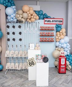 a room filled with balloons and other items on the wall next to a gas pump