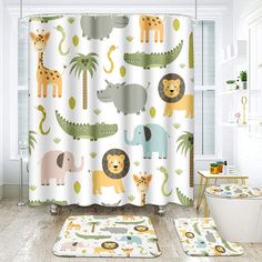 a bathroom with a shower curtain and rugs in the shape of elephants, giraffes, zebras and other animals