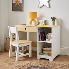 a small desk with a chair next to it and a star decoration on the wall