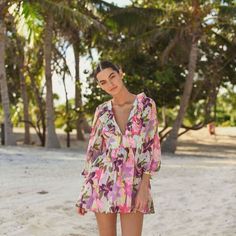 Tropical Pink Floral Print Mini. Smocked Waist And Zipper In Back. Feminine And Flirty V-neck Mini Dress With Smocked Bodice For Beach, Beach Mini Dress With Smocked Bodice And V-neck, Beach V-neck Mini Dress With Smocked Bodice, Long Sleeve Mini Dress With Smocked Back For Beach, Smocked Mini Beach Dress, Spring Tropical Dress With Smocked Back, Chic Smock Beach Dress, Bohemian Beach Mini Dress With Smocked Bodice, Chic Beach Smock Dresses