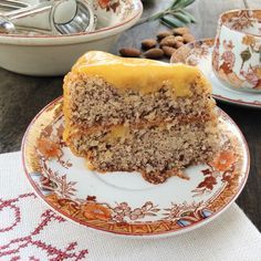 a piece of cake sitting on top of a plate next to a cup and saucer