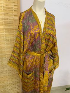 **this is a ONE of a kind vintage eco silk kimono only one in all the world  just like you :) ✨ this luxury's fabric had gone a long journey,  hand picked from special places  to bring you the most silky Beautiful ones we could find in order to recycle and create this unique goddess kimono  *you may find some imperfections in fabric,  this should be loved as a reminder of this fabrics journey  ⚛️ it's a one loss free size. so it's also great as a gift 🎁  can also be Warren as a wrap dress  has Yellow Bohemian Kimono With Kimono Sleeves, Bohemian Yellow Long Sleeve Kimono, Long Yellow Robe For Spring, Yellow Bohemian Kimono, Bohemian Yellow Kimono For Festivals, Yellow Bohemian Kimono For Festival, Long Yellow Kimono For Festivals, Vintage Green Kimono For Festival, Vintage Long Kimono For Vacation