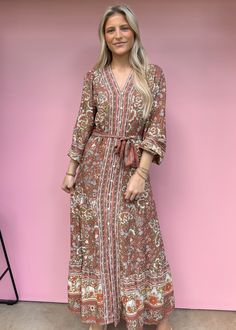 Say hello to your new go-to dress! Our Camellia Floral Maxi Dress features a playful floral print, long sleeves, and a flattering V-neckline. The lightweight and flowy fabric make it perfect for any occasion, while the belted waist adds an extra touch of flirty fun. Available in two colors, this dress is sure to turn heads at any event. True to size Olivia is 5'7 wearing small Color: Brown All over floral print maxi dress Functioning front buttons Adjustable tie belt V-Neck Long-sleeves Not lined Non-sheer. Lightweight Fabric: 100% Viscose Fabric has no stretch Floral Dress Casual, Flowy Fabric, Black Short Dress, Floral Print Maxi Dress, Floral Print Maxi, Vacation Dresses, Viscose Fabric, Dressy Casual, Dress With Cardigan