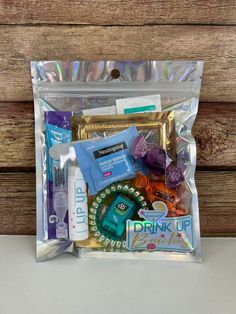 a bag filled with various items sitting on top of a wooden table next to a wall