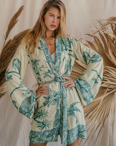 Our Short Kimono offers an easy, relaxed fit, combining comfort with understated elegance. Its fluid silhouette adds a touch of effortless charm to any outfit, making it a versatile piece for both casual days and special moments. Chic Long Sleeve Kimono For Loungewear, Elegant Long Sleeve Relaxed Fit Kimono, Elegant Long Sleeve Sleepwear For Vacation, Chic Spring Robe For Brunch, Elegant Relaxed Fit Sleepwear For Spring, Elegant Long Sleeve Robe For Vacation, Elegant V-neck Sleepwear For Vacation, Elegant Spring Loungewear Robe, Chic Long Sleeve Summer Robe