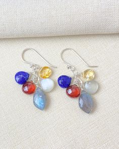 These drop earrings are a cascade of vibrant gemstones, including labradorite, lapis, citrine, and spessartite garnet. The multi-colored gems gleam in bright sterling silver. Earring drop: 1.5 inches Materials: sterling silver, labradorite, lapis lazuli, citrine, spessartite garnet, gray moonstone Multicolor Gemstone Accented Drop Earrings, Multicolor Dangle Earrings With Gemstone Accents, Multicolor Teardrop Earrings With Gemstone Accents, Multicolor Multi-stone Teardrop Earrings, Multicolor Gemstone Long Drop Earrings, Multicolor Long Drop Gemstone Earrings, Multicolor Teardrop Jewelry With Gemstone Accents, Multicolor Teardrop Gemstones For Jewelry Making, Multicolor Multi-stone Briolette Earrings