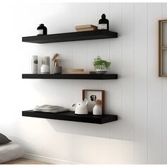 two black floating shelves in a white room