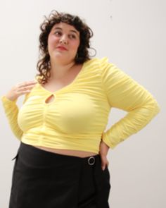 This luxe top is oh-so-flattering and shows just the cheekiest amount of cleavage. Subtle yet sexy, this is your newest fall go-to. Full ruched details in the front, back, and sleeves with cotton twill tape detail. Wear this plus-size cutout top with a cute skort for a cute look. Lovefool Pucker Up Cutout Ruched Top | Lemon | Tops | Materials & Care Instructions: ['58% Cotton, 4% Spandex, 38% Rayon', 'Machine wash cold', 'Imported'] Trendy Tunic, Yellow Tops, Cutout Top, Night Tops, Women Figure, Chic Blouses, Ruched Top, Keyhole Neckline, Cut Out Top