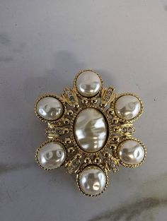 "Vintage St John Gold Tone Hammered Pearl and Rhinestone Brooch Excellent pre-owned vintage condition. All pearls and rhinestones are intact set in bright gold tone metal Pin on back, but also has hinge to be a necklace pendant 2.25\" in diameter Purchased in 2003 for $125" Gold Jeweled Brooches For Formal Occasions, Formal Gold Jeweled Brooches, Victorian Jeweled Gold Brooches, Gold Brooches With Rhinestones For Anniversary, Vintage Gold Brooches With Rhinestones, Ornate Jeweled Gold Brooches, Ornate Gold Jeweled Brooches, Gold Jeweled Costume Jewelry Brooch, Gold Jeweled Brooches For Wedding