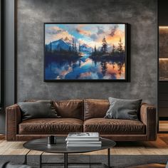 a living room filled with furniture and a painting hanging on the wall over a coffee table