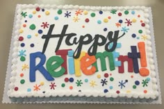 a birthday cake with the words happy retirement spelled in colorful icing on white frosting