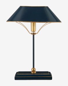 a table lamp with a blue shade on it's base and gold trimmings