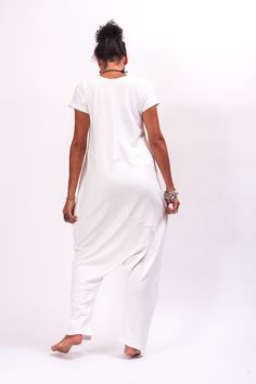 Who's the freshest of them all? It's you in the off white jumpsuit women! This short sleeves jumpsuit features, two side pockets for convenient storage. Coming in a minimal design, this quilted romper women comes with hidden zipper closure on the back and short sleeves. This drop crotch jumpsuit is cut in a loose silhouette and has a long leg. The off white overalls women is made of a soft cotton blend to keep your feelin' comf' and chilled out. Perfect for slaying in the streets, pair this off Oversized Jumpsuits And Rompers With Pockets For Loungewear, Relaxed Fit Jumpsuits And Rompers For Loungewear, Relaxed Fit Overalls Jumpsuit For Loungewear, Relaxed Fit Overalls For Loungewear, Baggy Loungewear Jumpsuits And Rompers With Pockets, Cotton Overall Jumpsuits For Loungewear, Cotton Loungewear Jumpsuit Overall, Cotton Jumpsuit For Loungewear, Cotton Loungewear Overalls