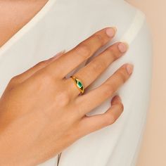 A gorgeous design, this cocktail ring is boldly unexpected. Stunning in its simplicity, the ring features an inlay pear-shaped emerald beautifully set in a gold band that packs a punch. Band is made of 14k gold over sterling silver. Hypoallergenic, nickel and lead free Tarnish resistant H2O sensitive. Before showering or working out, remove your plated jewelry. Clean your piece by buffing gently with a dry cloth and store it in your pouch. Gold Teardrop Emerald Ring, Yellow Gold Teardrop May Birthstone Ring, Yellow Gold Teardrop Ring For May Birthstone, Gold Teardrop Emerald Promise Ring, Pear-shaped Gold Emerald Ring, Modern Emerald Ring For Anniversary, Elegant Pear-shaped Green Rings, Modern Emerald Anniversary Ring, Classic Teardrop Emerald Ring As Gift