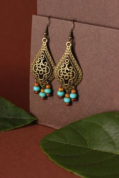 "These unique boho earrings was made of big drop shape antique brass charms, tiny czech glass \"picasso\" style blue,brown beads and antiqie brass earring hooks. Earring hooks are from nickel free and lead free metal. A wonderful jewelry for you or an unique gift for someone speacial! *The total lenght of earrings is about 67 mm including earring hooks. Other earrings of my shop you can see here: https://www.etsy.com/shop/NaTavelli?section_id=13757927 Thanks for visit." Bohemian Bronze Chandelier Earrings For Pierced Ears, Brass Chandelier Earrings For Festivals, Vintage Dangle Beaded Earrings For Festival, Brass Chandelier Drop Earrings For Festival, Bohemian Teardrop Jewelry With Dangling Beads, Bohemian Bronze Chandelier Earrings, Bronze Bohemian Chandelier Earrings, Bohemian Bronze Earrings With Dangling Beads, Brass Dangle Chandelier Earrings For Festivals