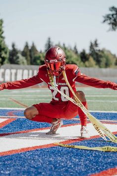 a man in red uniform holding a lacrosse stick