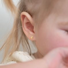 Adorn your sweet little girl with this dainty pair of polished heart earrings. Crafted entirely from a solid 14k yellow gold, your daughter will never want to take them off. They feature screw backs that will stay safely in place and your little girl will be super comfortable wearing them all day and night. This delicate pair of earrings comes carefully packaged so they are ready for gifting. Age Group: Lovely for Babies, Toddlers & Little Girls; Safe for Sensitive Skin Material: 14k Yellow Gold Earring Size: 5mm x 5mm Heart; 7mm threaded earring post Metal Stamp: 14k Gift Box Included Baby With Earrings Children, Baby Wearing Earrings, Toddler Earrings, Post Metal, Thread Earrings, Earring Post, Kids Earrings, Heart For Kids, Gold Earring